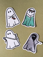 four stickers on christmas carol inspired sheet ghosts. Featuring Ghost of christmas past holding a branch of holly, ghost of christmas present with holly crown and green robe, ghost of christmas yet to come in a black robe poiting with a skeleton hand, and a marley ghost in chains