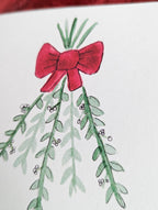 close up image of a watercolor and pen drawing of mistletoe branches tied with a red bow