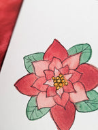 a close up of a watercolor poinsettia on a white background