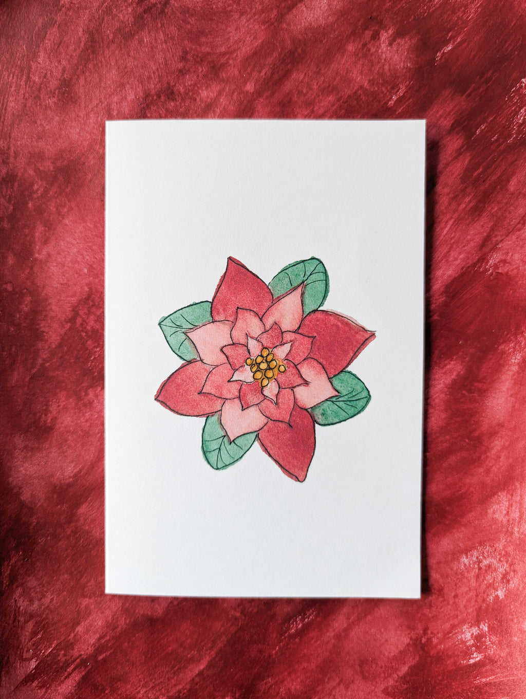 a holiday greeting card of a watercolor and pen poinsettia flower on a white background